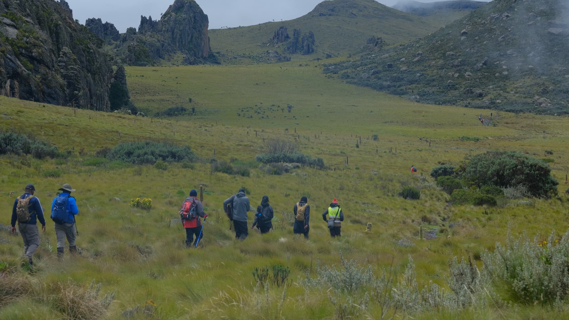 Tai Trails group walking across Aberdare moorland toward the Satima crags