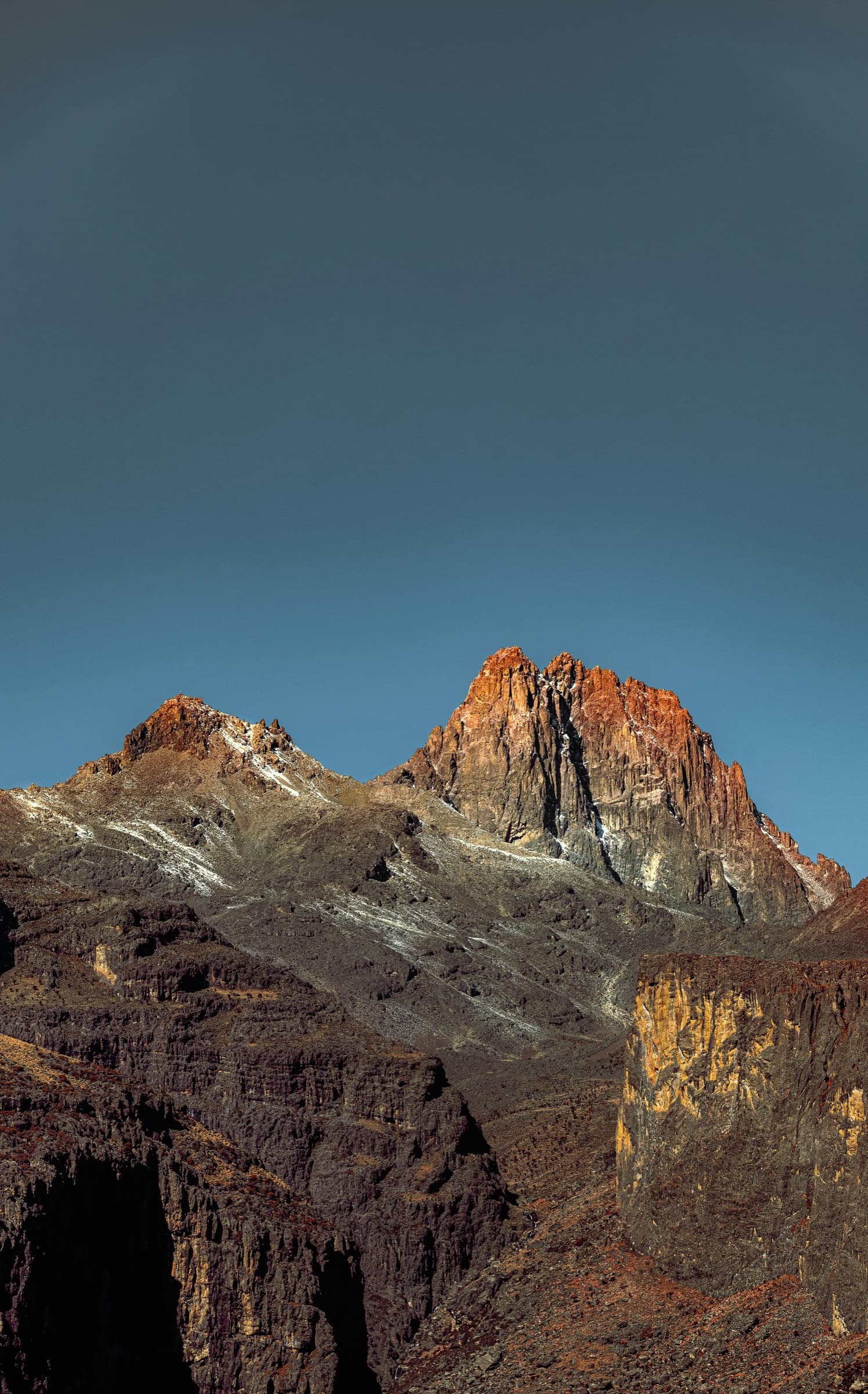 Mount Kenya's Batian and Nelion spires lit by golden hour light