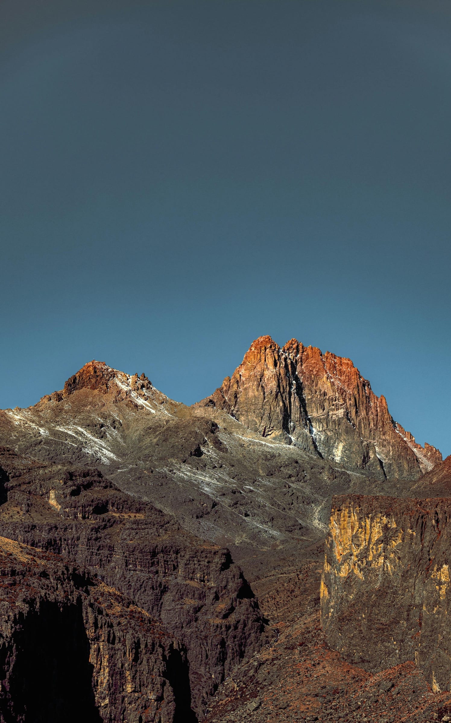 Mount Kenya's Batian and Nelion spires lit by golden hour light
