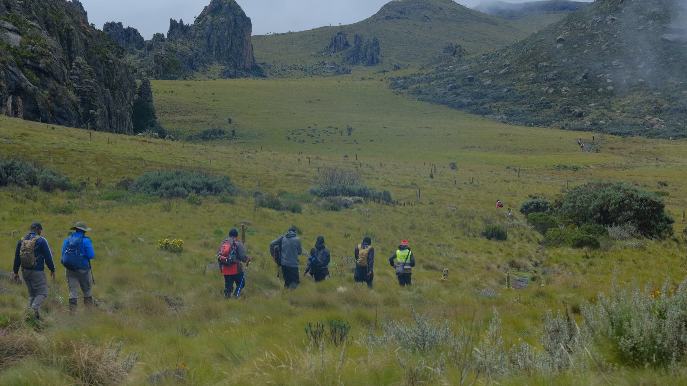 Tai Trails group walking across Aberdare moorland toward the Satima crags